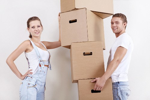 Professional team handling goods with a removal truck